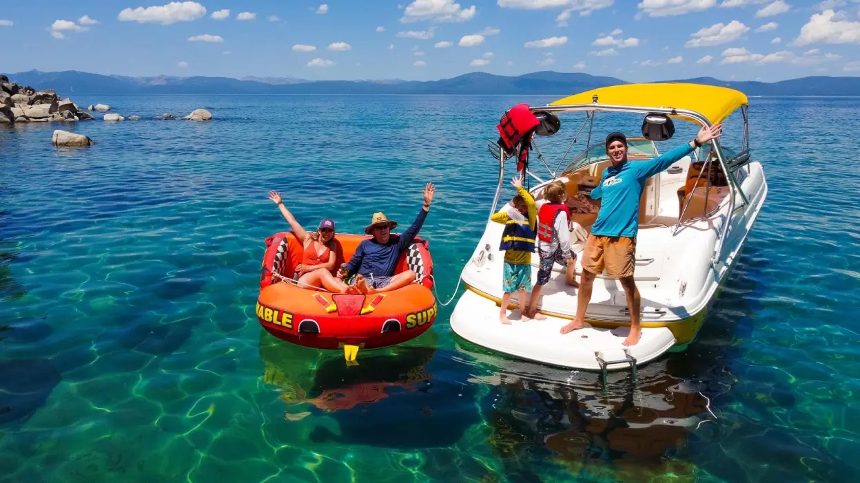 Bumble-with-tube-and-bimini-capt-scotty-opt Things to Do Lake Tahoe Tahoe Charter Boat Tour Wake Tubing The best Lake Tahoe Boating Experience