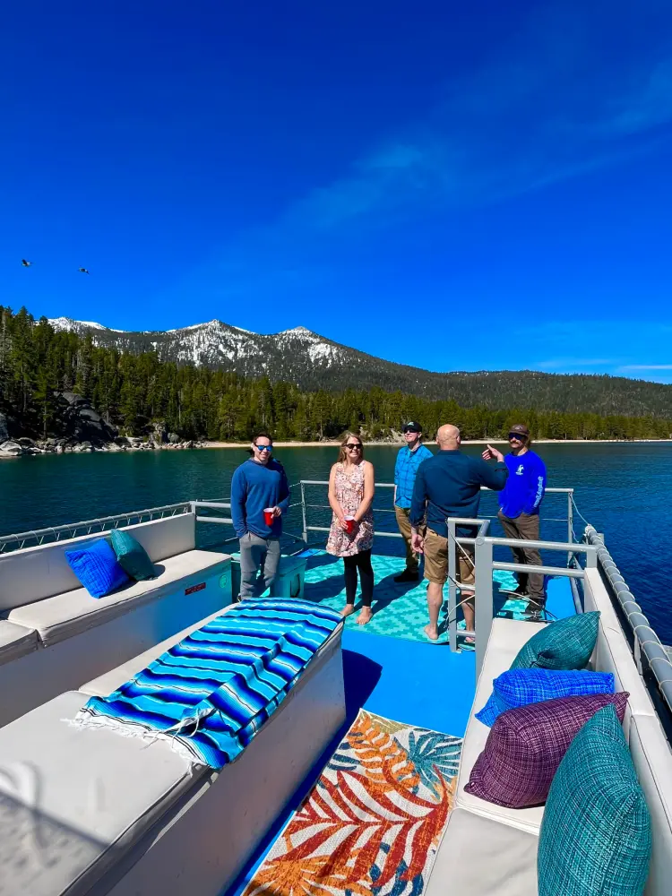 Group of people standing on Lake Tahoe party boat rental by Lake Tahoe Boat Rides